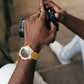 Gold Kairos on wrist of man hold camera